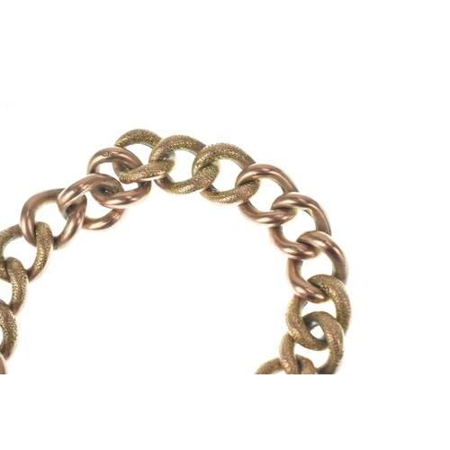 47 - A 9ct gold curb link bracelet, having alternating textured and plain links, fitted with an engraved ... 