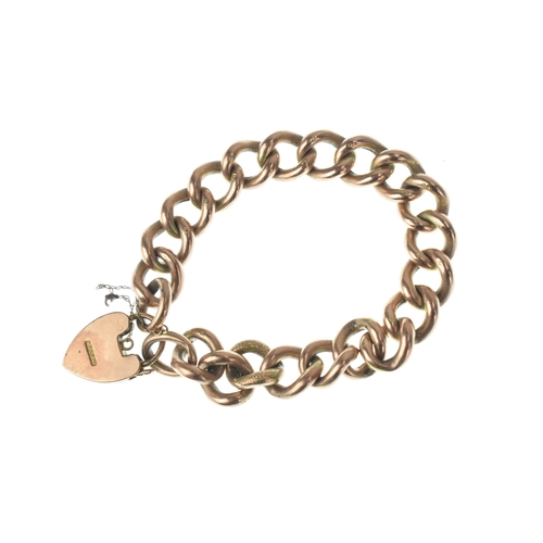 47 - A 9ct gold curb link bracelet, having alternating textured and plain links, fitted with an engraved ... 