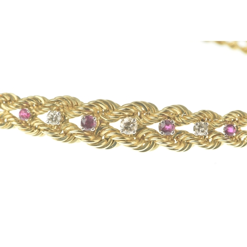 56 - A ruby and diamond 9ct gold bracelet, formed of twin rope-twist chains with a central tapering secti... 
