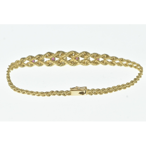 56 - A ruby and diamond 9ct gold bracelet, formed of twin rope-twist chains with a central tapering secti... 