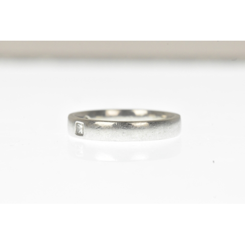 7 - A diamond-set white metal wedding band, set with three princess-cut diamonds spaced evenly around a ... 