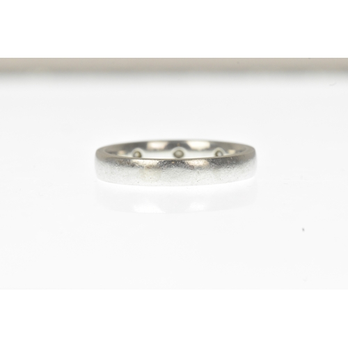 7 - A diamond-set white metal wedding band, set with three princess-cut diamonds spaced evenly around a ... 