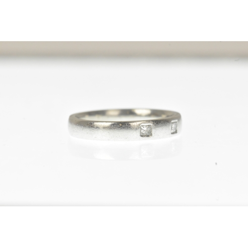 7 - A diamond-set white metal wedding band, set with three princess-cut diamonds spaced evenly around a ... 