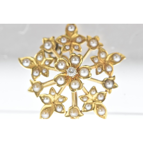8 - A seed pearl and diamond yellow gold floral brooch, set throughout with seed pearls and centred by a... 