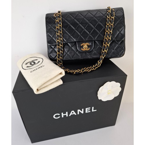 Chanel- A black quilted lambskin classic double flap shoulder bag, 25cm wide x 16cm high, having an intertwined gold tone and black leather shoulder strap, serial number 7713765, complete with branded box, dust bag and third party Certificate of Authenticity. Location:Cab
Condition:Wear to internal flap from chain strap, light surface scratches to hardware clasp, wear to the leather strip interlined amongst the gold chain strap, slight wear to corners at the base, the serial number sticker is intact, lining clean and intact-see additional photos