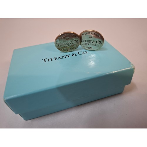 10 - Tiffany & Co- A pair of silver Return to Tiffany cufflinks having an iconic turquoise branded dust b... 