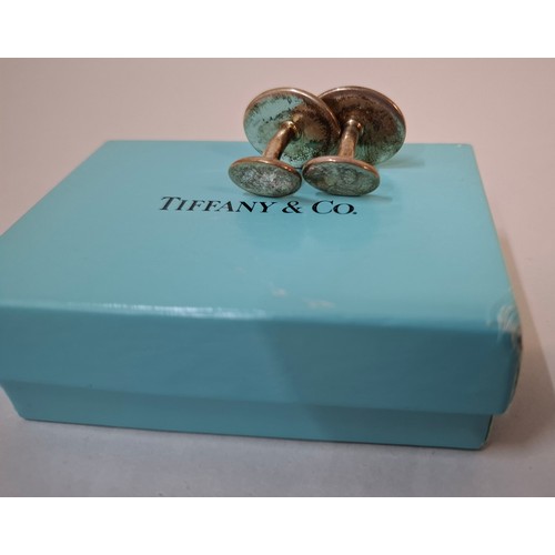 10 - Tiffany & Co- A pair of silver Return to Tiffany cufflinks having an iconic turquoise branded dust b... 