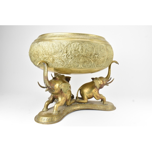 14 - A large Indian brass Paththara ceremonial bowl on elephant stand, early/mid 20th century, the bowl d... 
