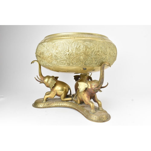 14 - A large Indian brass Paththara ceremonial bowl on elephant stand, early/mid 20th century, the bowl d... 