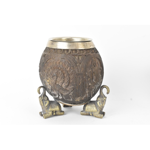15 - Two Victorian Indian carved coconuts, one applied with Electro silver plate on brass mounts, each ca... 