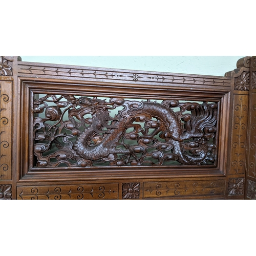 15A - A circa 1900 Chinese carved hardwood five-panel screen, reputedly from Peking Palace, each panel pro... 