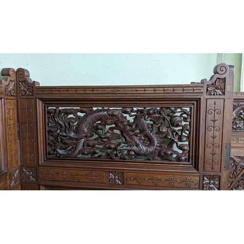 15A - A circa 1900 Chinese carved hardwood five-panel screen, reputedly from Peking Palace, each panel pro... 