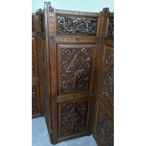 15A - A circa 1900 Chinese carved hardwood five-panel screen, reputedly from Peking Palace, each panel pro... 
