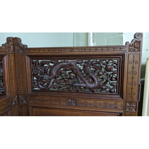 15A - A circa 1900 Chinese carved hardwood five-panel screen, reputedly from Peking Palace, each panel pro... 