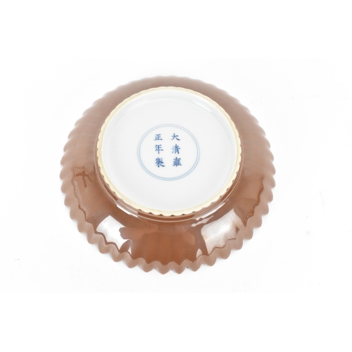 17 - A Chinese café-au-lait glazed chrysanthemum dish, 20th century, moulded with petals, the base with a... 
