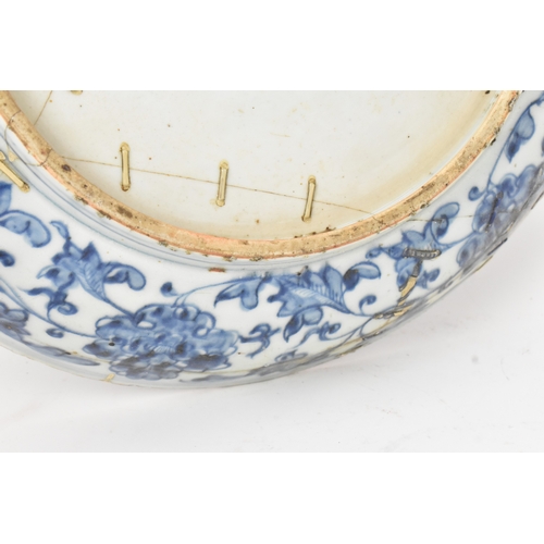 22 - A Chinese Ming dynasty blue and white charger, painted with a phoenix amidst scrolling peony and bir... 
