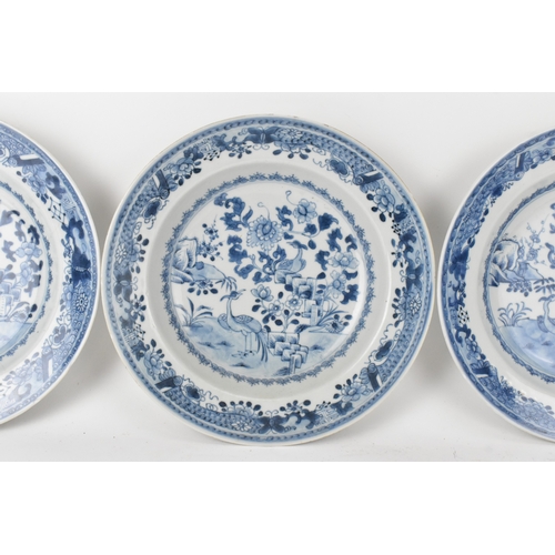 23 - A group of three Chinese Qing Dynasty blue and white porcelain plates, 18th century, each painted to... 