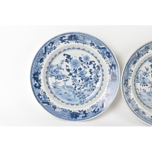 23 - A group of three Chinese Qing Dynasty blue and white porcelain plates, 18th century, each painted to... 