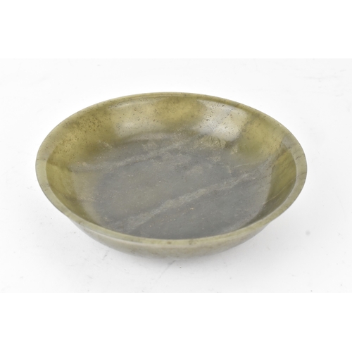 27 - A Chinese spinach green jade bowl, of circular shallow form with recessed footrim, the underside inc... 