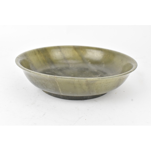 27 - A Chinese spinach green jade bowl, of circular shallow form with recessed footrim, the underside inc... 