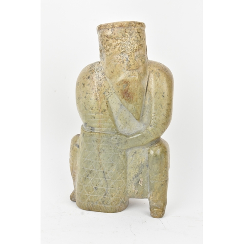 28 - A Chinese carved hardstone figure and an archaistic hardstone blade-form carving, the figure modelle... 