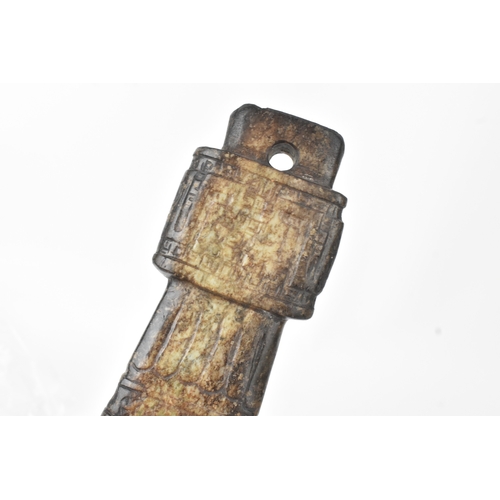 28 - A Chinese carved hardstone figure and an archaistic hardstone blade-form carving, the figure modelle... 