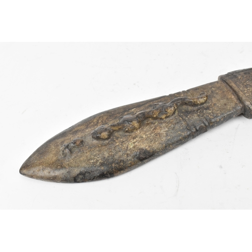 28 - A Chinese carved hardstone figure and an archaistic hardstone blade-form carving, the figure modelle... 