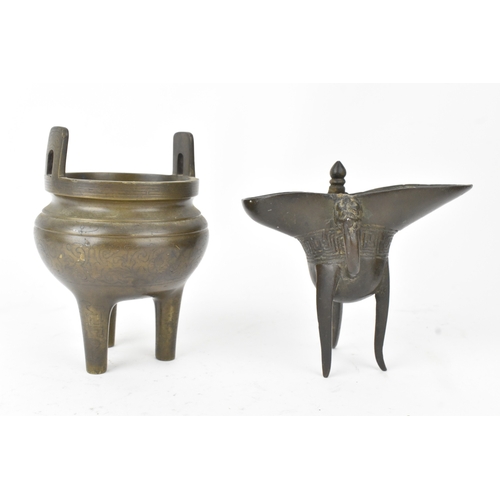 29 - A pair of Chinese bronze tripod vessels, comprising a ding with engraved decoration and an apocrypha... 