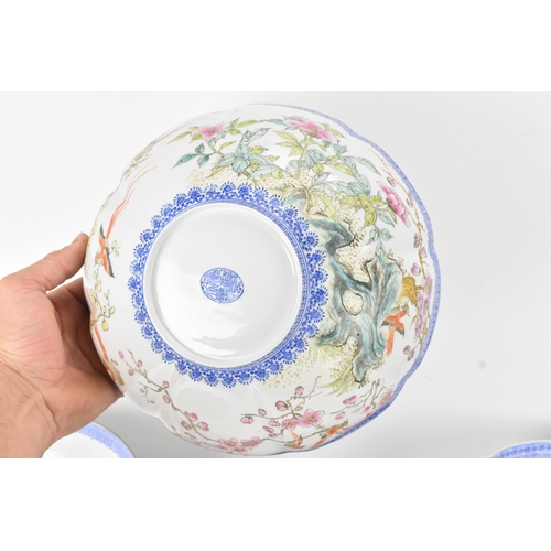34 - A group of five Chinese famille rose egg shell porcelain bowls, with blue enamel borders, decorated ... 