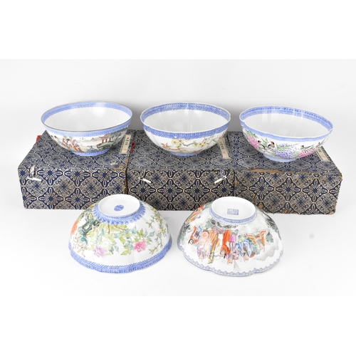 34 - A group of five Chinese famille rose egg shell porcelain bowls, with blue enamel borders, decorated ... 