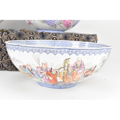 34 - A group of five Chinese famille rose egg shell porcelain bowls, with blue enamel borders, decorated ... 