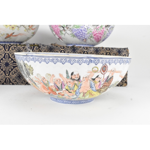 34 - A group of five Chinese famille rose egg shell porcelain bowls, with blue enamel borders, decorated ... 