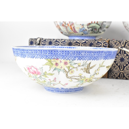 34 - A group of five Chinese famille rose egg shell porcelain bowls, with blue enamel borders, decorated ... 