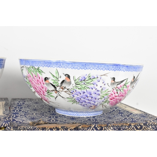34 - A group of five Chinese famille rose egg shell porcelain bowls, with blue enamel borders, decorated ... 