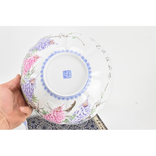 34 - A group of five Chinese famille rose egg shell porcelain bowls, with blue enamel borders, decorated ... 