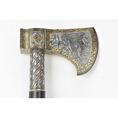 38 - A 19th century Indo-Persian 'tabarzin' saddle axe, the steel head decorated with a hunting scene dep... 