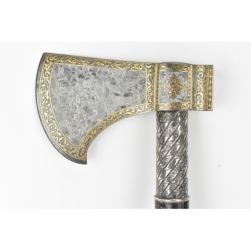 38 - A 19th century Indo-Persian 'tabarzin' saddle axe, the steel head decorated with a hunting scene dep... 