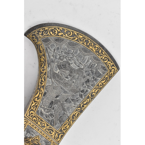 38 - A 19th century Indo-Persian 'tabarzin' saddle axe, the steel head decorated with a hunting scene dep... 