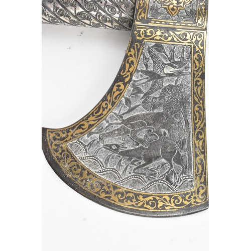 38 - A 19th century Indo-Persian 'tabarzin' saddle axe, the steel head decorated with a hunting scene dep... 