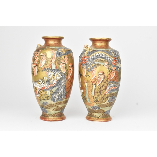 4 - A pair of Japanese Satsuma vases, late Meiji period, decorated in gilt with dragons and figures, aga... 