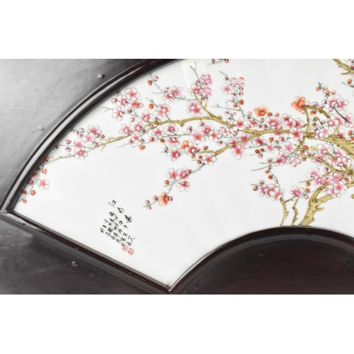 41 - A Chinese famille rose porcelain fan-shaped panel, 20th century, painted with blossoming prunus bran... 