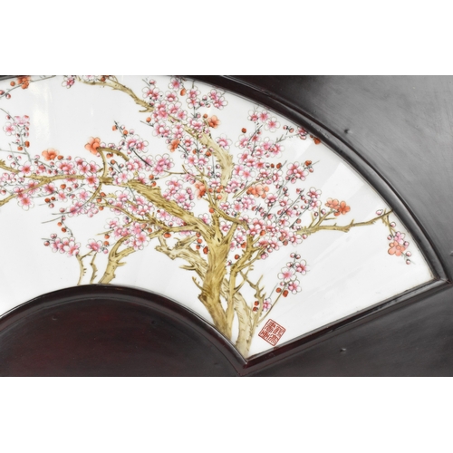 41 - A Chinese famille rose porcelain fan-shaped panel, 20th century, painted with blossoming prunus bran... 
