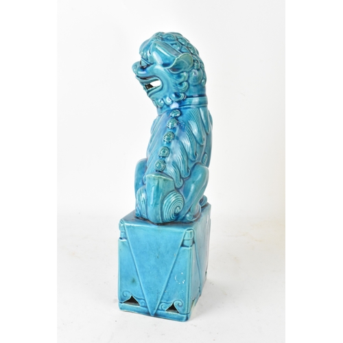 42 - A Chinese turquoise-glazed pottery model of a Foo dog, early/mid 20th century, modelled seated on a ... 