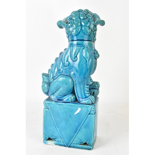 42 - A Chinese turquoise-glazed pottery model of a Foo dog, early/mid 20th century, modelled seated on a ... 