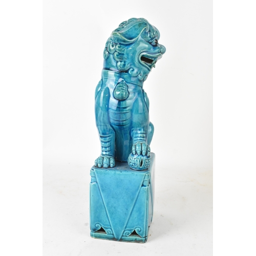 42 - A Chinese turquoise-glazed pottery model of a Foo dog, early/mid 20th century, modelled seated on a ... 