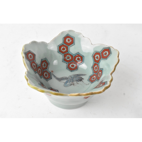 45 - A Japanese porcelain lobed bowl, late Edo/early Meiji period, hand painted with a crane in flight am... 
