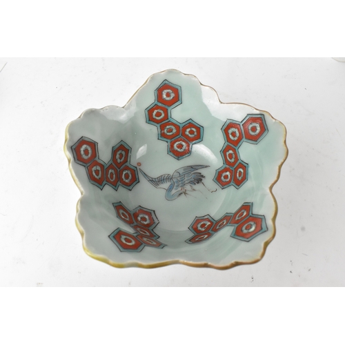 45 - A Japanese porcelain lobed bowl, late Edo/early Meiji period, hand painted with a crane in flight am... 