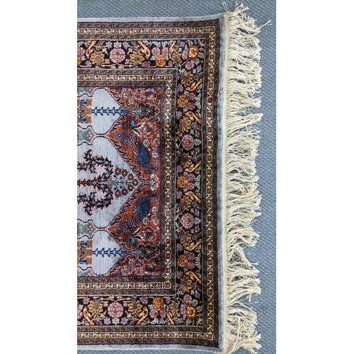 48 - A Persian part silk rug, with central mihrab design flanked by flowering columns, stylised vases, tr... 