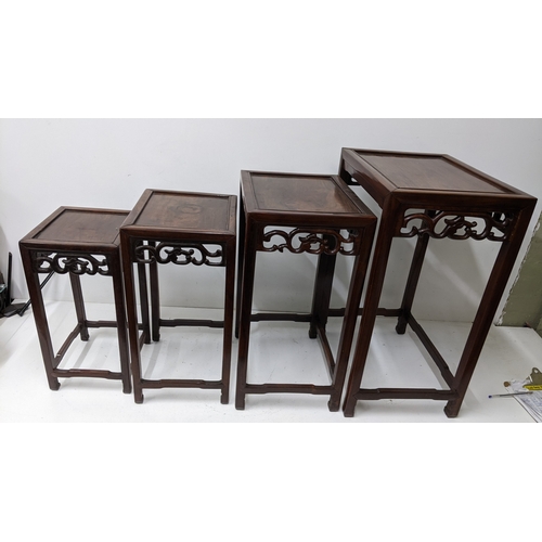 49 - A nest of four Chinese hardwood occasional tables, each rectangular top with moulded edge above a pi... 