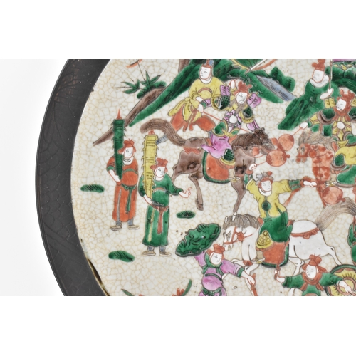 8 - A pair of Chinese famille verte-style crackleware chargers, late Qing dynasty, each painted with war... 